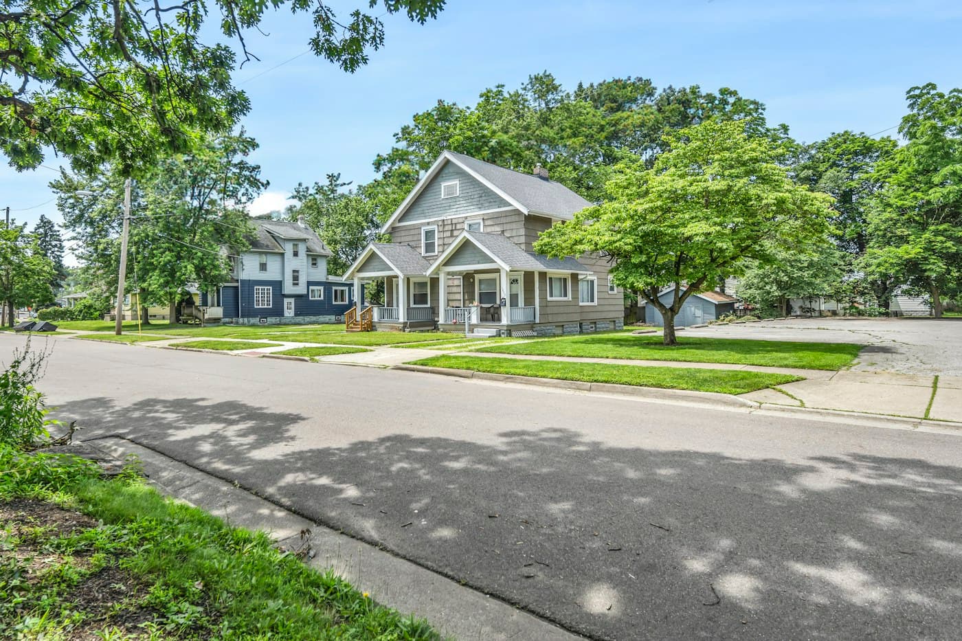 Street-level view of homes on a tree-lined street